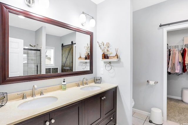 bathroom featuring vanity, an enclosed shower, tile patterned floors, and toilet