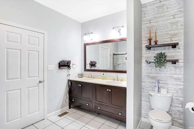 bathroom featuring tile patterned flooring, vanity, and toilet