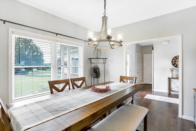 dining area featuring a notable chandelier and dark wood-type flooring