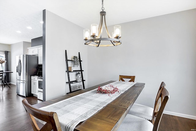 dining area featuring dark hardwood / wood-style floors and a chandelier