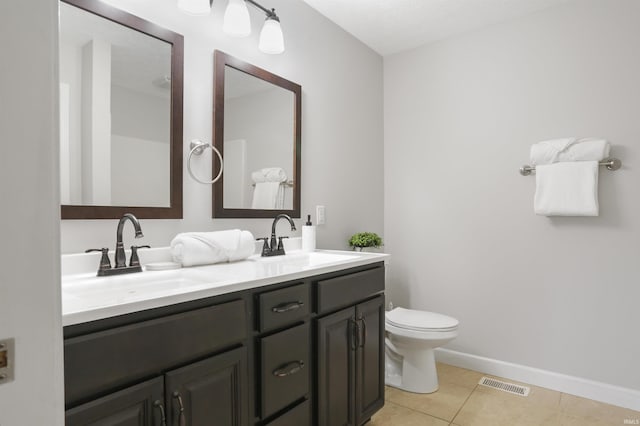 bathroom featuring vanity, tile patterned floors, and toilet