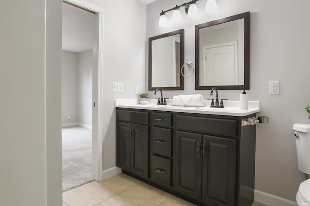 bathroom with tile patterned flooring, vanity, and toilet