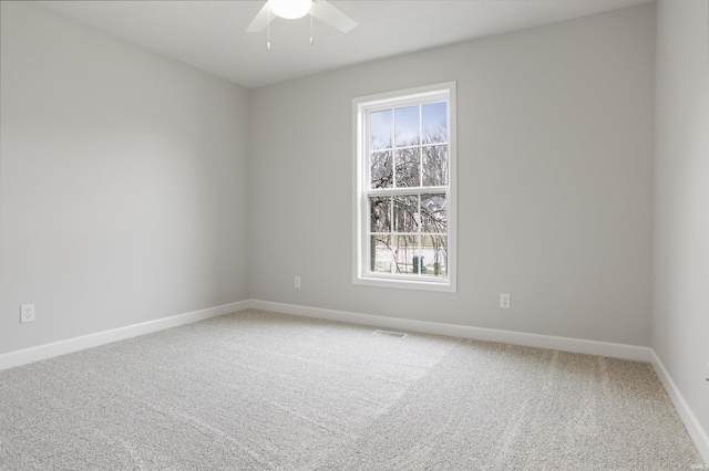 carpeted empty room featuring ceiling fan