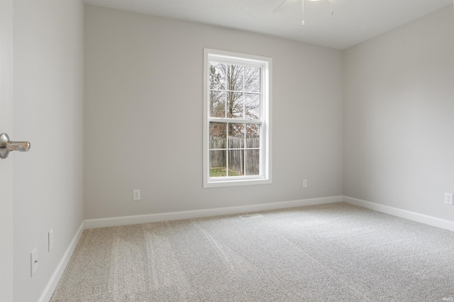 carpeted spare room with a healthy amount of sunlight