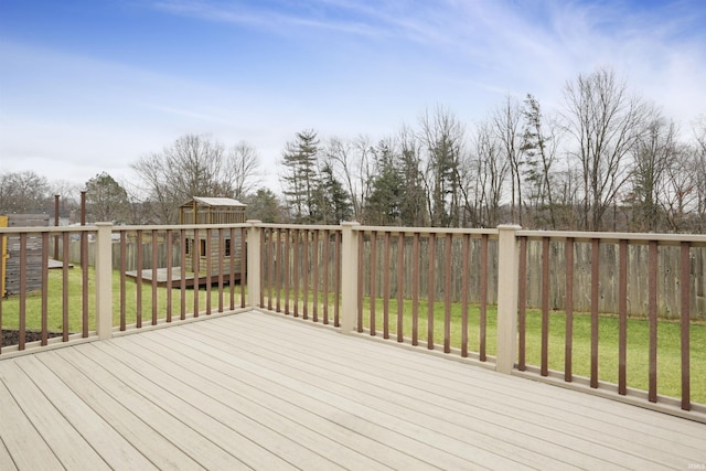 wooden deck featuring a lawn