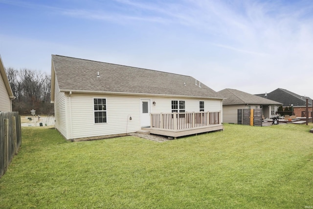 back of property featuring a yard and a deck