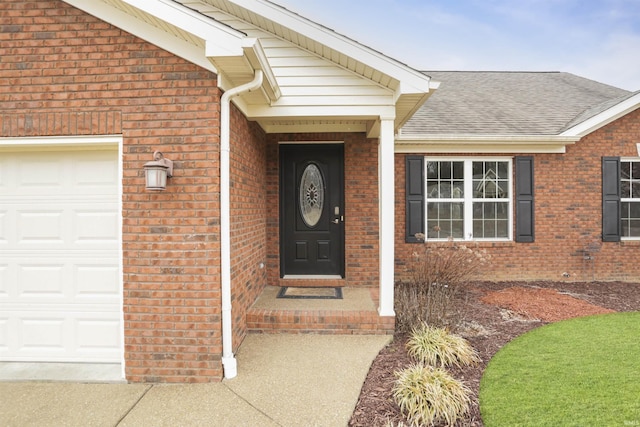 view of exterior entry with a garage