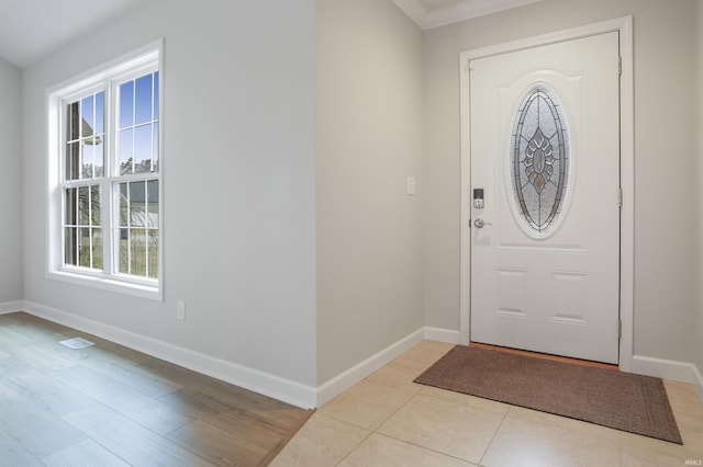 foyer entrance with light tile patterned flooring