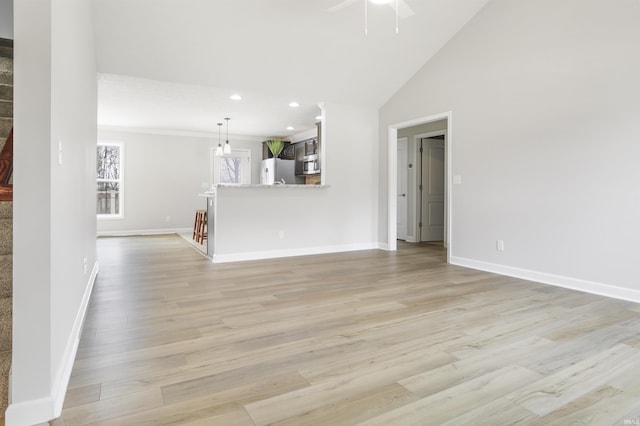 unfurnished living room featuring high vaulted ceiling, ceiling fan, and light wood-type flooring