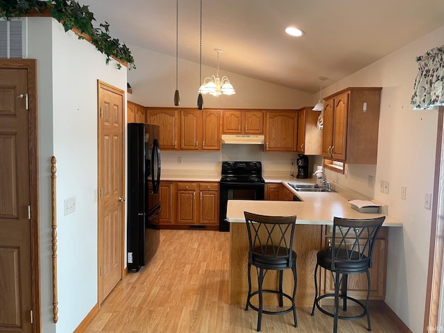 kitchen featuring sink, vaulted ceiling, light hardwood / wood-style flooring, kitchen peninsula, and black appliances