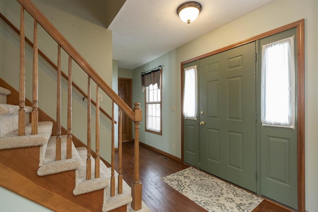 foyer entrance featuring dark hardwood / wood-style flooring