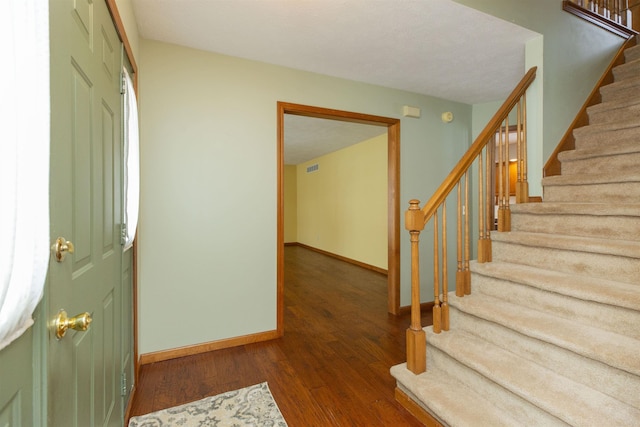 entryway with dark hardwood / wood-style floors