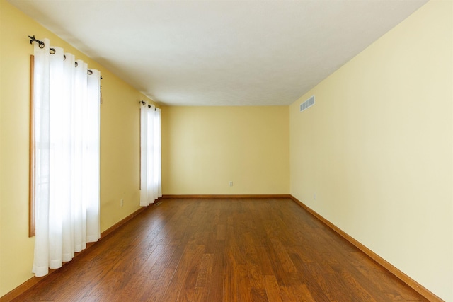 empty room featuring dark hardwood / wood-style flooring