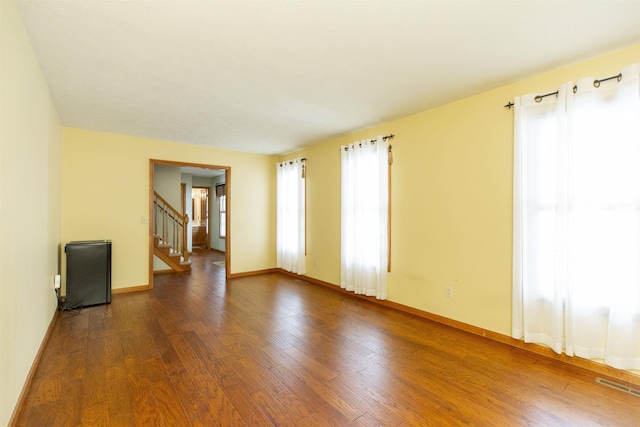 spare room featuring dark wood-type flooring