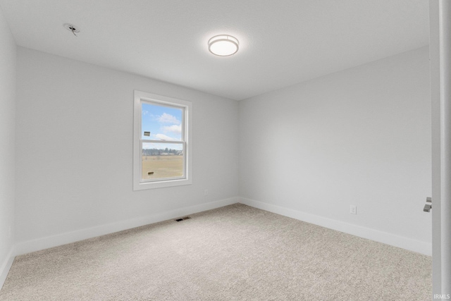 unfurnished room featuring carpet