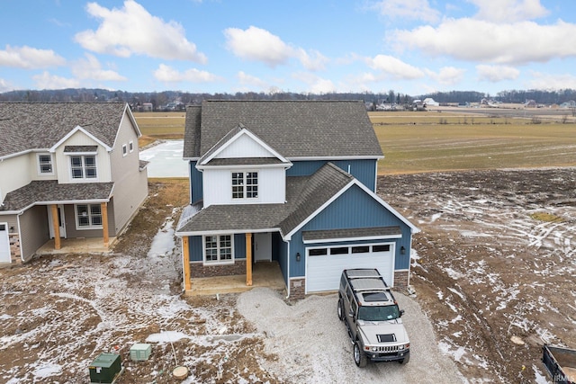 view of front of property featuring a rural view and a garage