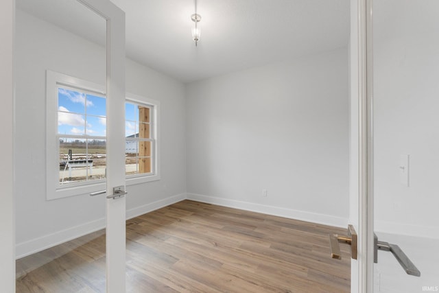 spare room with light hardwood / wood-style flooring