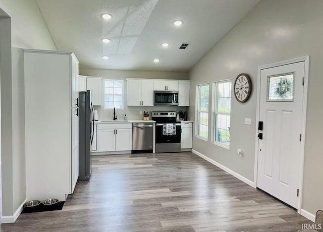 kitchen with white cabinetry, a healthy amount of sunlight, stainless steel appliances, and sink