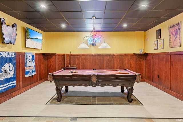 game room featuring light hardwood / wood-style flooring, a drop ceiling, wooden walls, and billiards