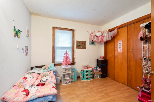 bedroom with a closet and light hardwood / wood-style flooring