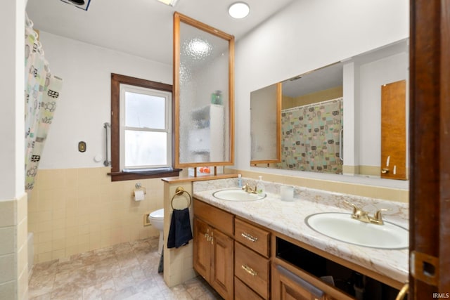 bathroom featuring vanity, tile walls, a shower with shower curtain, and toilet