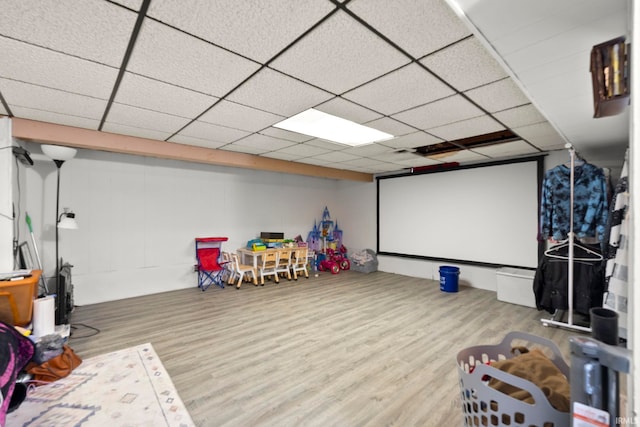 home theater with hardwood / wood-style floors and a drop ceiling