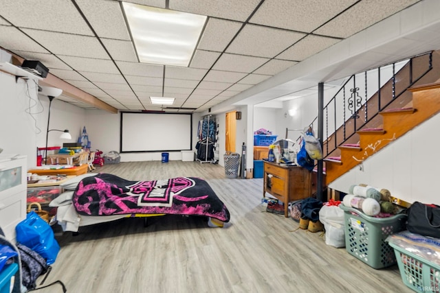 interior space with light hardwood / wood-style floors and a drop ceiling