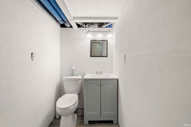 bathroom with vanity, wood-type flooring, and toilet