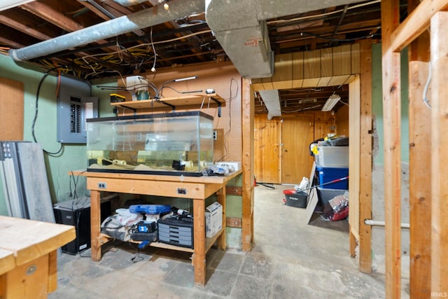 basement with electric panel and a workshop area