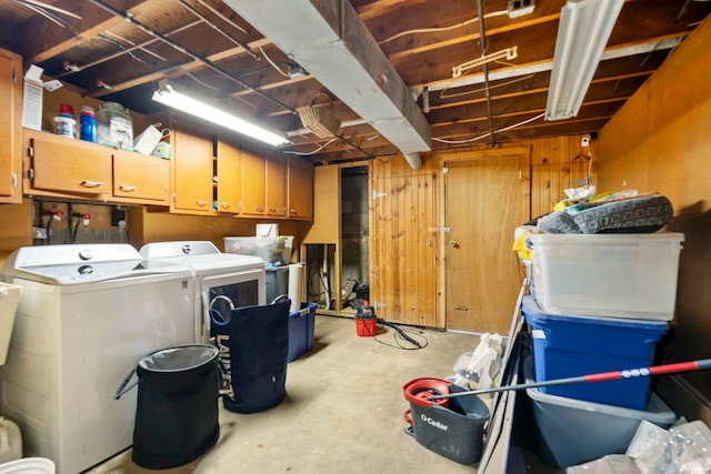 basement with washer and dryer and wood walls