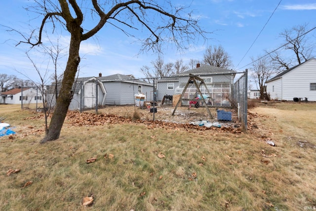 back of property with an outbuilding and a yard