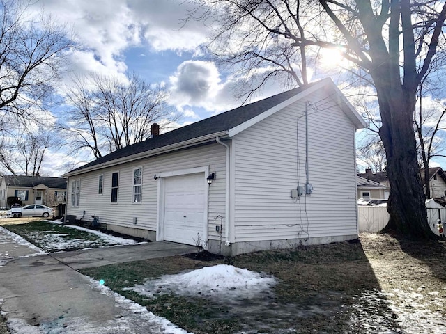 view of snowy exterior with a garage