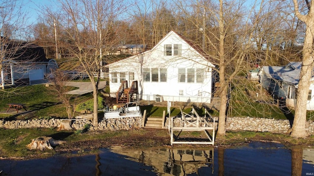 view of front of home with a dock and a water view