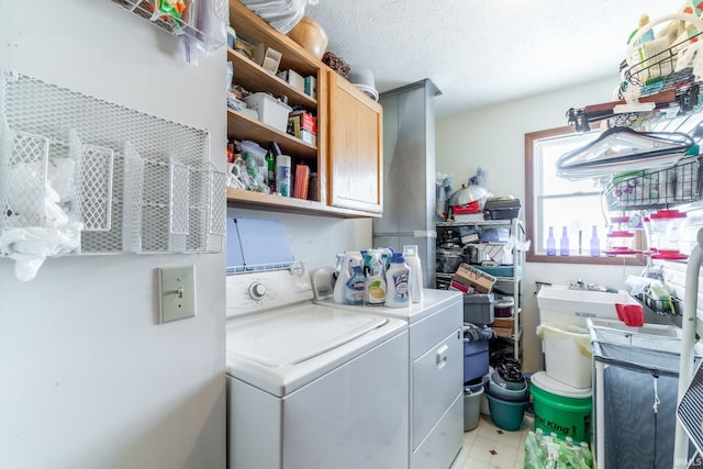 washroom with cabinets, separate washer and dryer, and a textured ceiling