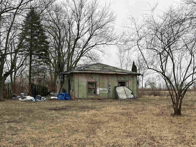 view of outbuilding featuring a lawn