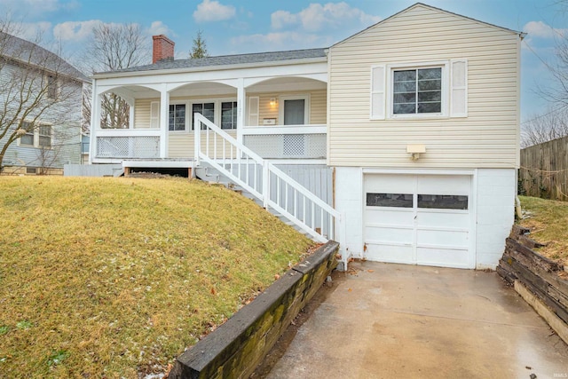 view of front of house with a garage, a porch, and a front lawn