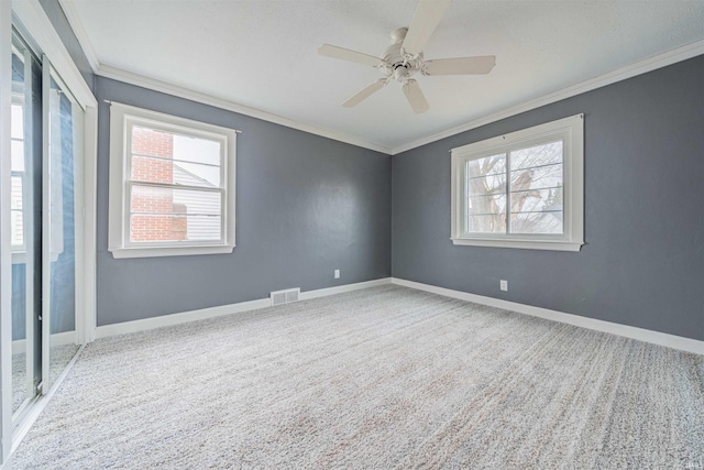 carpeted spare room with ornamental molding and ceiling fan