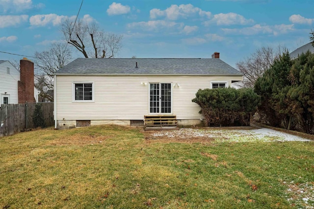 rear view of house featuring a yard