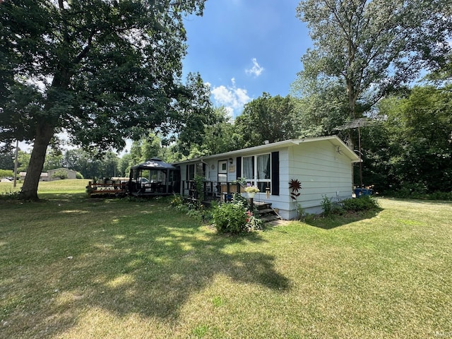 view of front of home with a gazebo and a front lawn