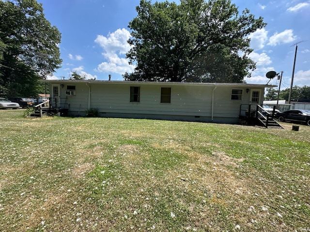 rear view of house featuring a lawn