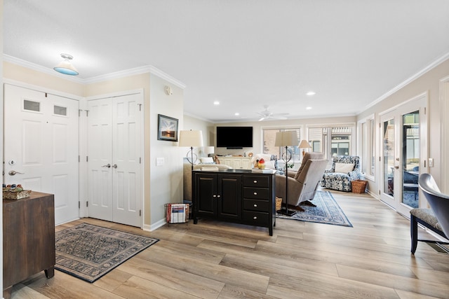 entrance foyer featuring ornamental molding, a wealth of natural light, and light hardwood / wood-style floors