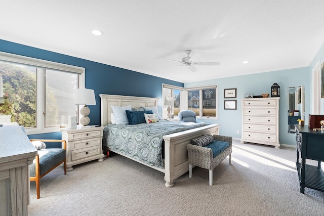 carpeted bedroom with multiple windows, ornamental molding, and ceiling fan