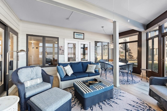 sunroom with beam ceiling and french doors