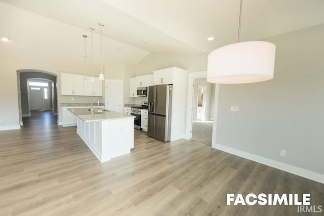 kitchen featuring white cabinetry, sink, stainless steel appliances, and an island with sink