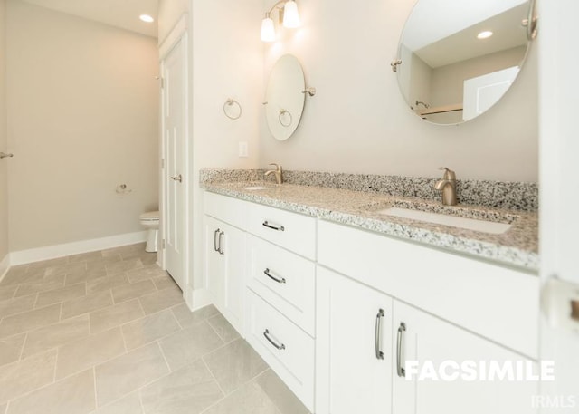 bathroom with vanity, toilet, and tile patterned flooring