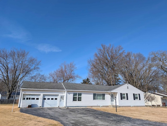 single story home with a garage and a front yard