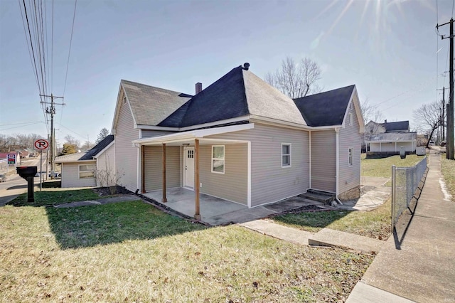 view of home's exterior featuring a patio and a yard