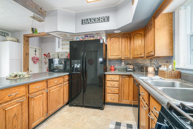 kitchen with sink, decorative backsplash, ornamental molding, and black appliances