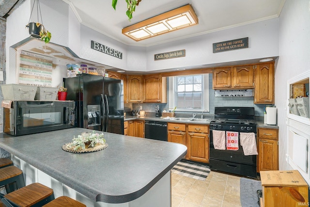 kitchen with a kitchen bar, sink, crown molding, black appliances, and backsplash