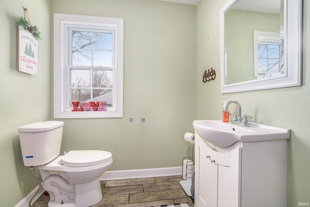 bathroom with vanity, hardwood / wood-style floors, and toilet